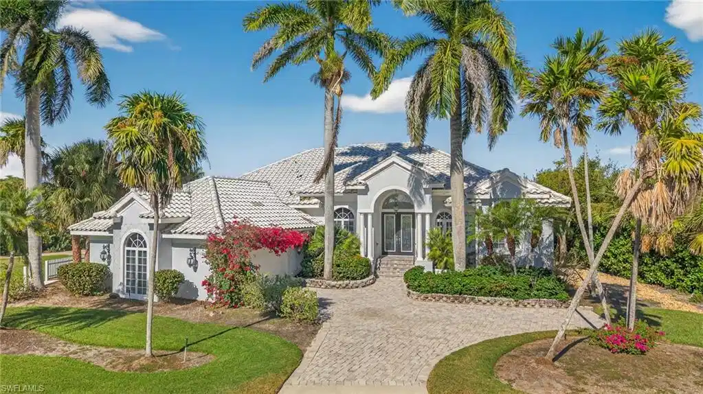 Image 1: Mediterranean / spanish-style home with french doors, stucco siding, a tiled roof, and decorative driveway