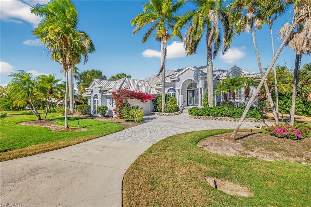 Image 2: View of front of house featuring stucco siding, a front lawn, decorative driveway, an attached garage, and a tile roof