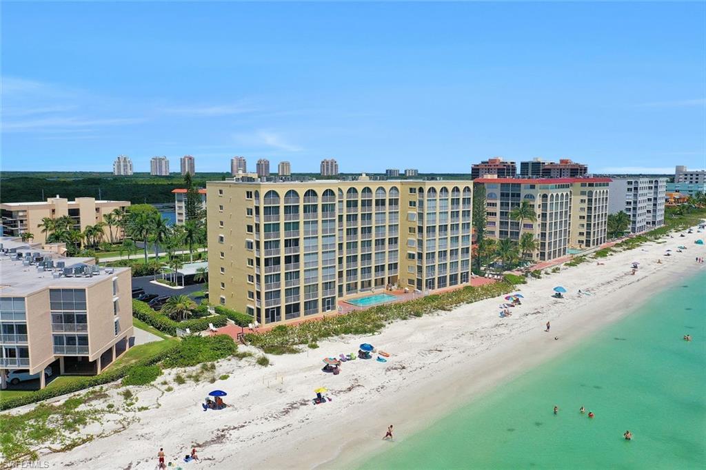 Image 2: Bird's eye view of apartment complex / building and waterfront with a beach