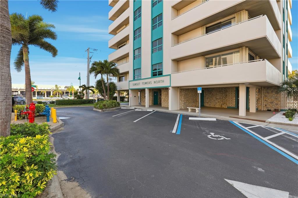 Image 2: View of building exterior with uncovered parking
