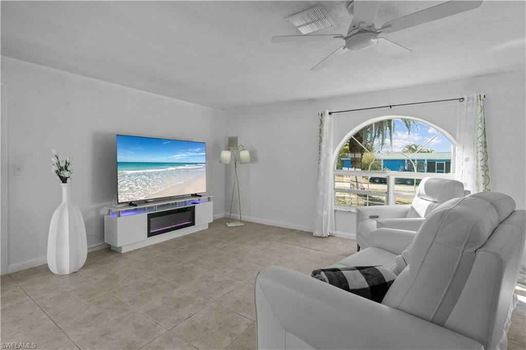 Image 4: Living area with ceiling fan and light tile patterned floors