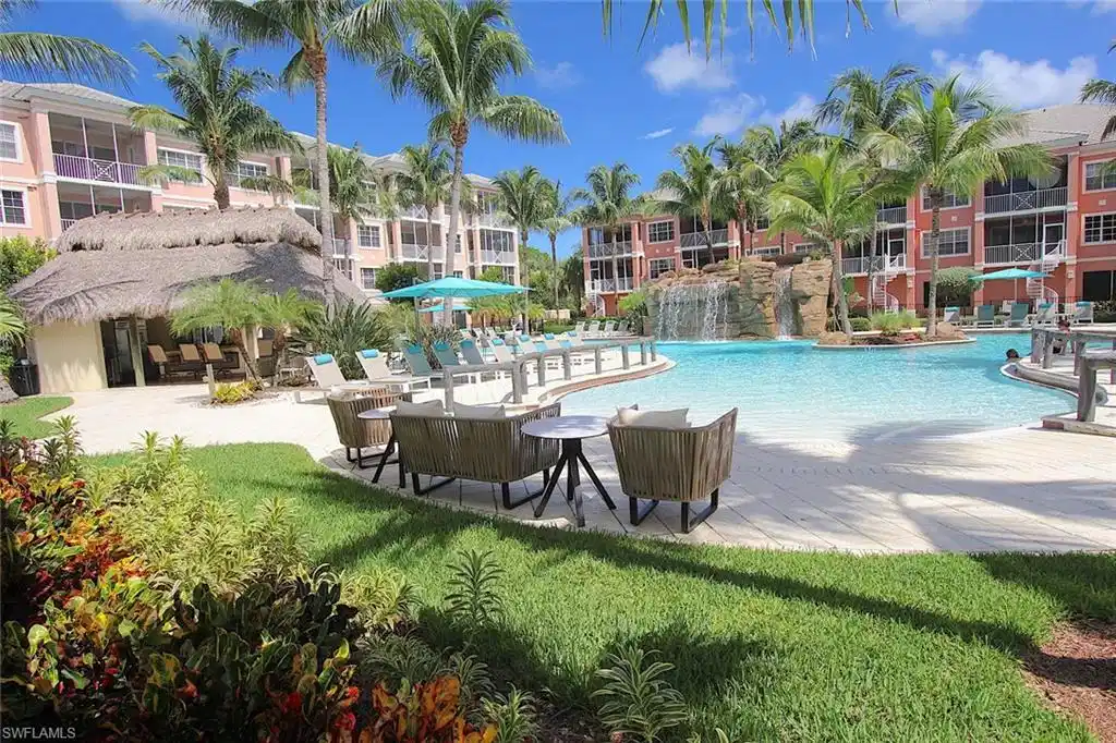 Image 1: View of swimming pool with a lawn and pool water feature