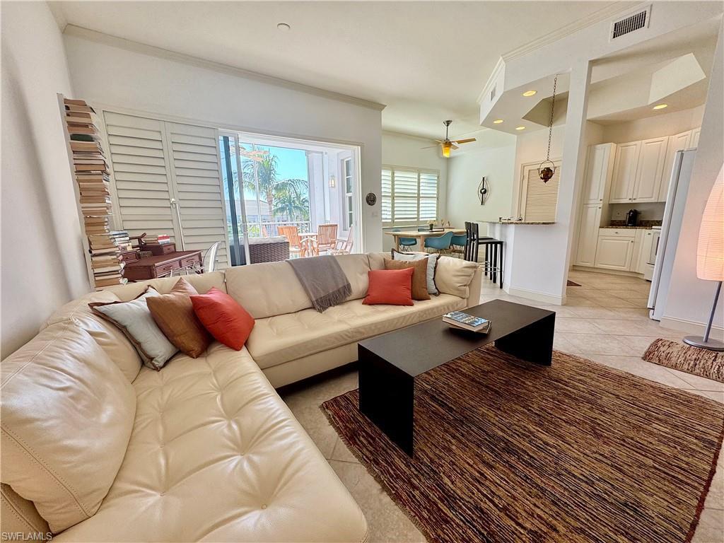 Image 2: Living room with light tile patterned floors