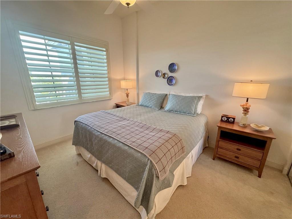 Image 4: Guest bedroom featuring ceiling fan and connected guest bathroom