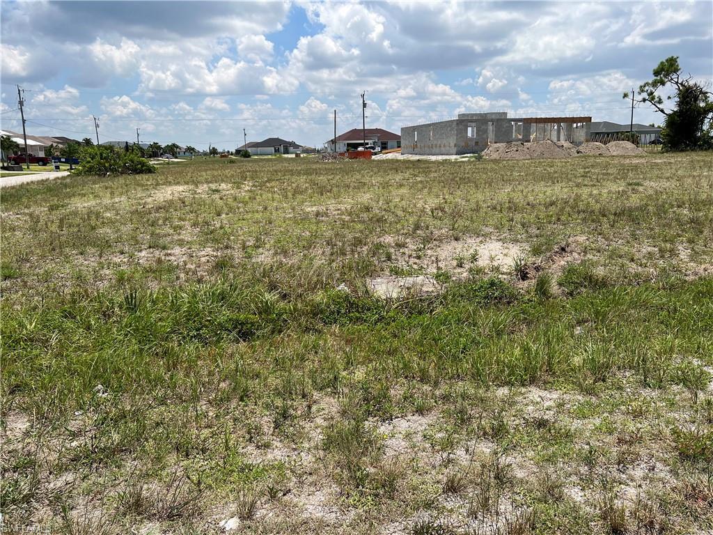 Image 3: View looking east of lot.  Flat, no clearing needed!