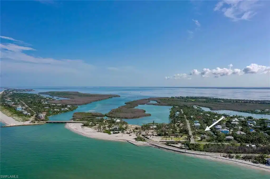 Image 1: Bird's eye view featuring a view of the beach and a water view
