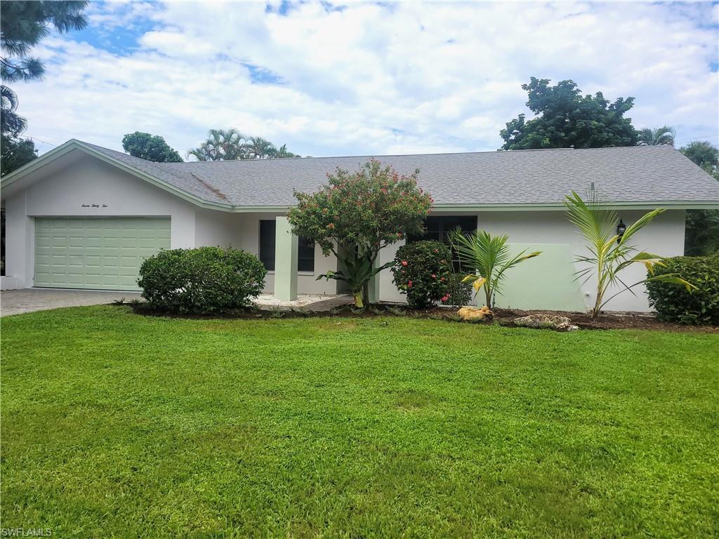 Image 1: Single story home featuring a front yard and a garage