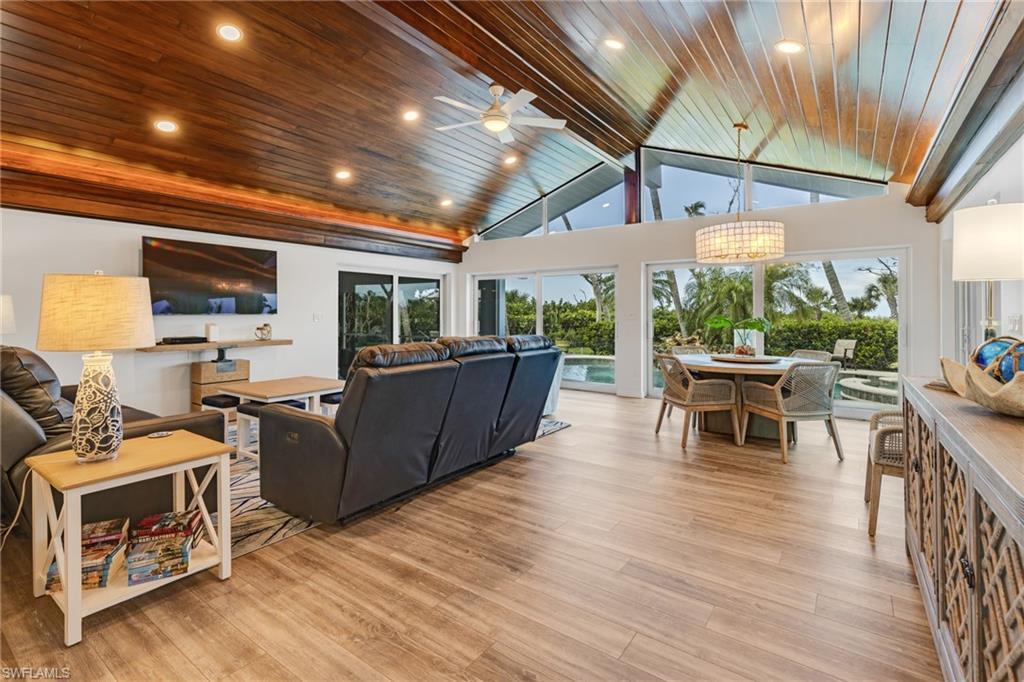 Image 2: Living room featuring a healthy amount of sunlight, light wood-type flooring, and wooden ceiling