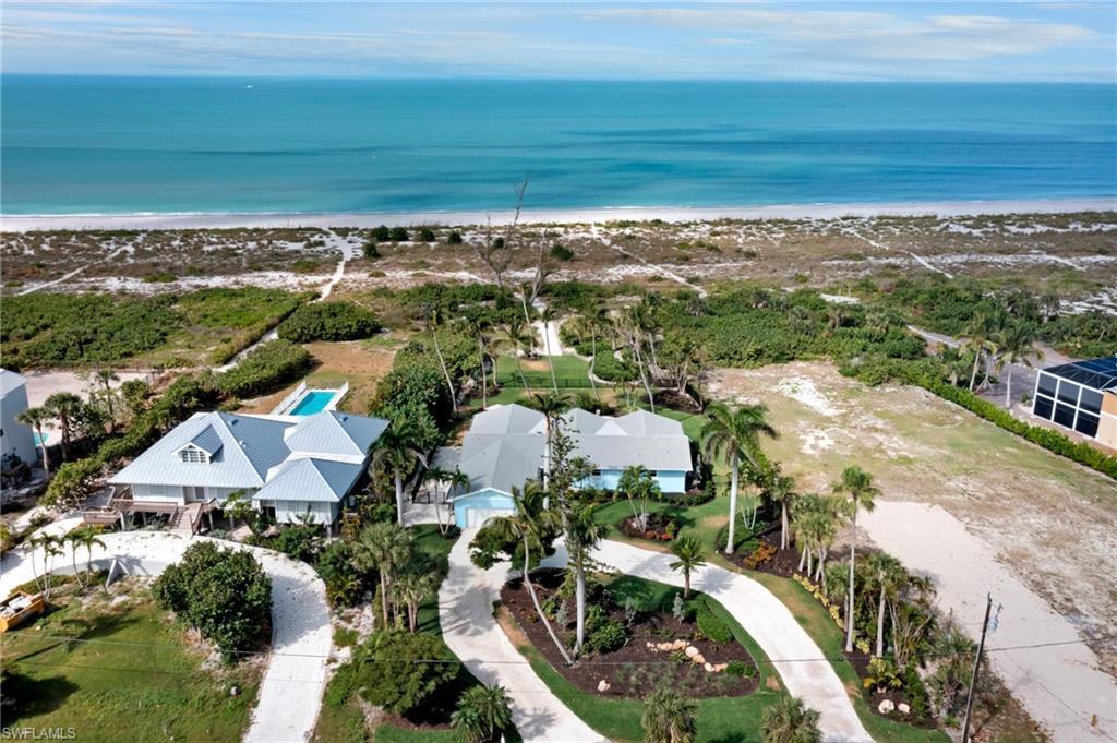 Image 3: Birds eye view of property featuring a water view and a view of the beach