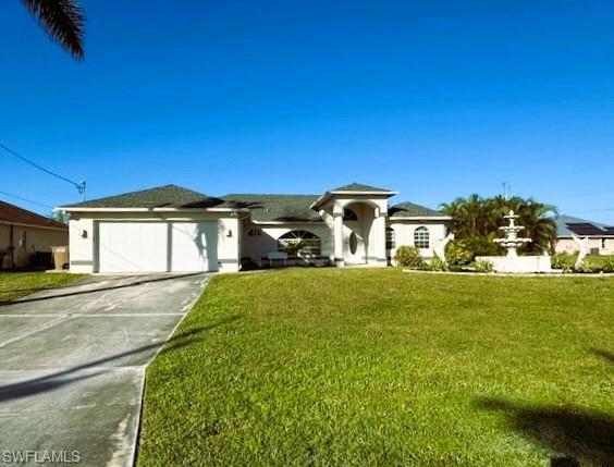 Image 1: Single story home featuring a garage and a front lawn
