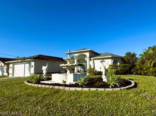 Image 3: View of front of home with a front yard and a garage