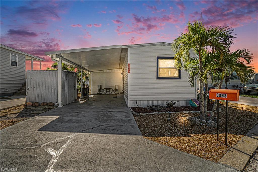 Image 1: Manufactured / mobile home with concrete driveway and a carport