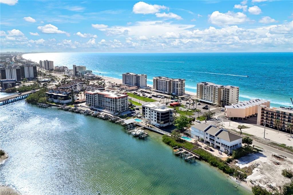 Image 1: Birds eye view of property showing its situation on the Bay, right across the street from Bonita Beach and the Gulf of Mexico