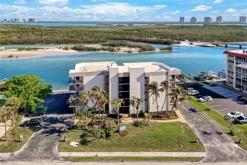 Image 2: Gulf Harbor Aerial view.  This low density building offers spacious condo living ideally situated on the Bay on the quiet north end of Little Hickory Island, home of Beautiful Bonita Beach!
