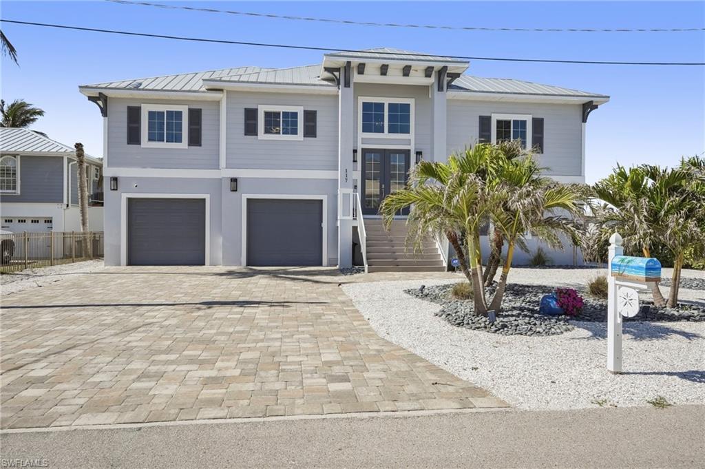 Image 3: View of front of property with a garage
