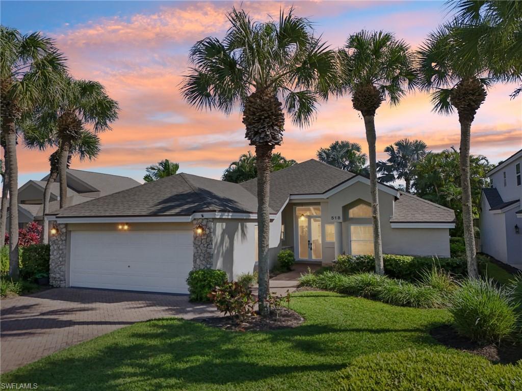 Image 1: View of front facade featuring decorative driveway, roof with shingles, stucco siding, an attached garage, and a front yard