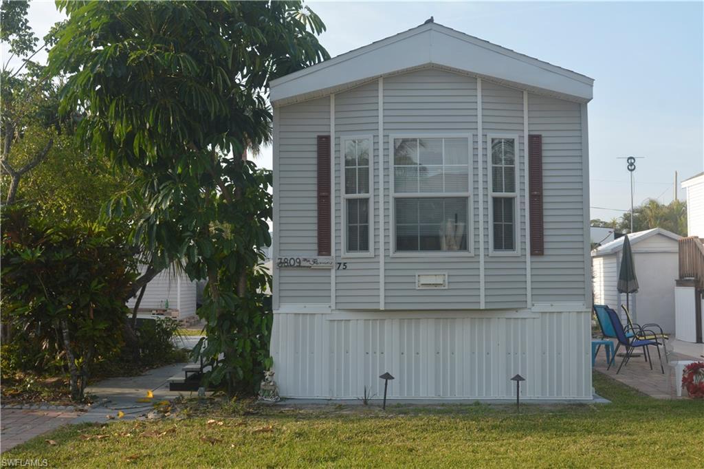 Image 1: View of home's exterior featuring a lawn and a patio area