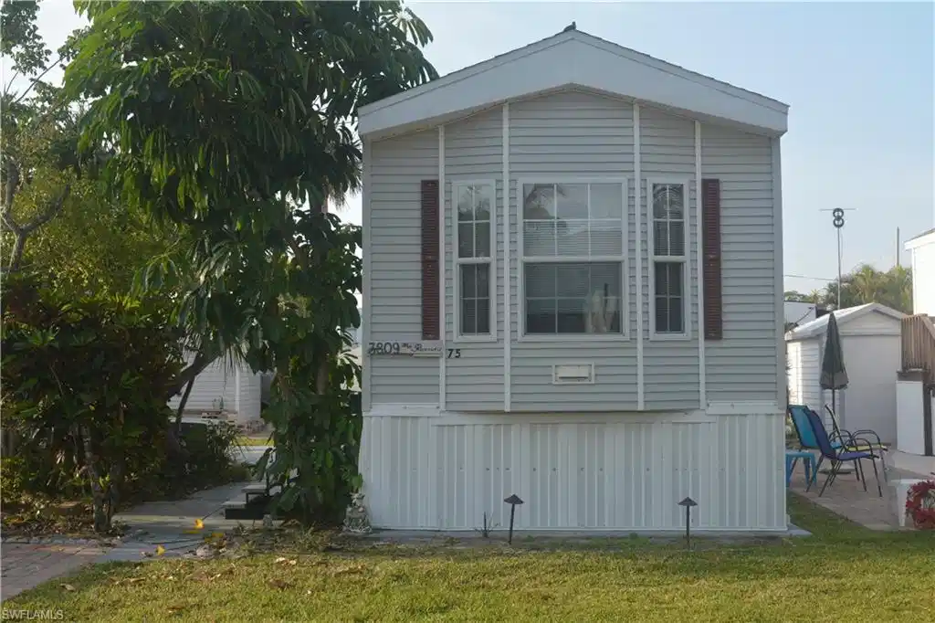 Image 1: View of home's exterior featuring a lawn and a patio area