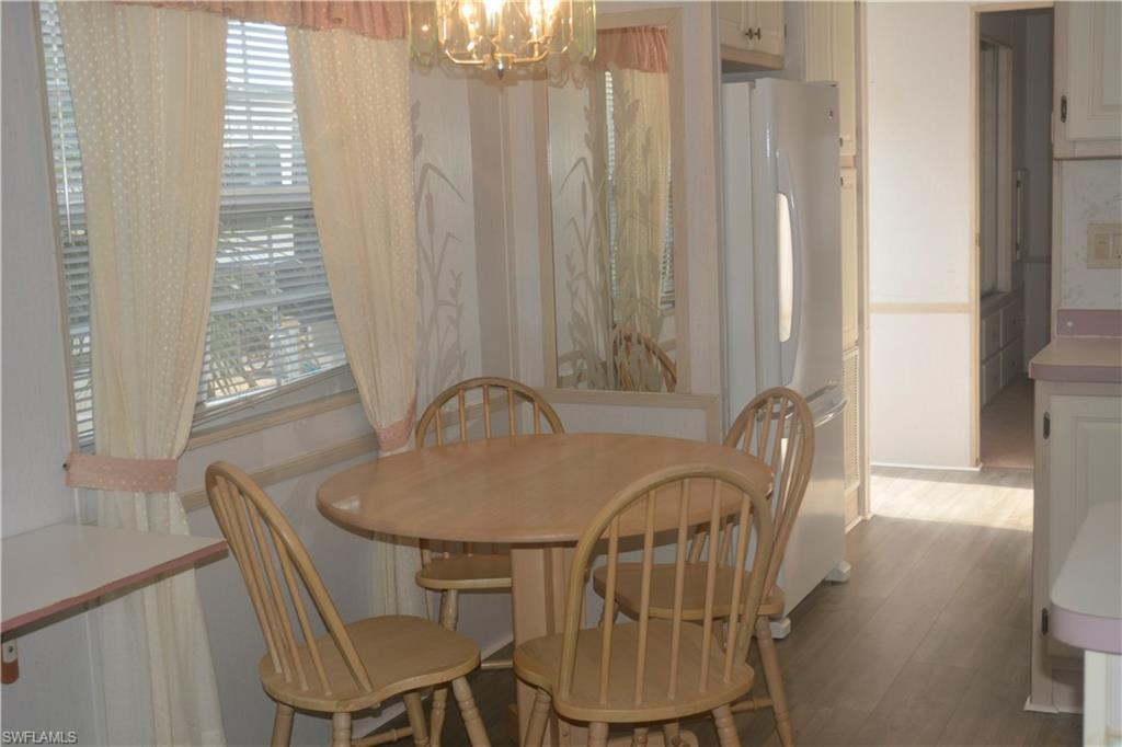 Image 2: Dining space featuring a notable chandelier and light wood finished floors