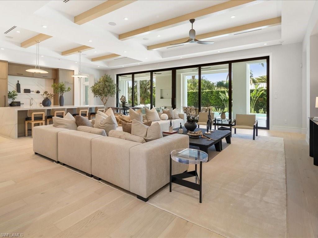 Image 3: Living area with beamed ceiling, baseboards, recessed lighting, a ceiling fan, and light wood-type flooring