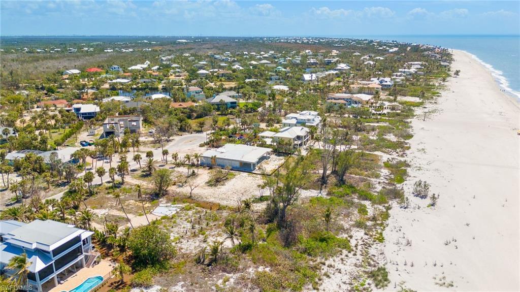 Image 1: Drone / aerial view featuring a residential view, a view of the beach, and a water view