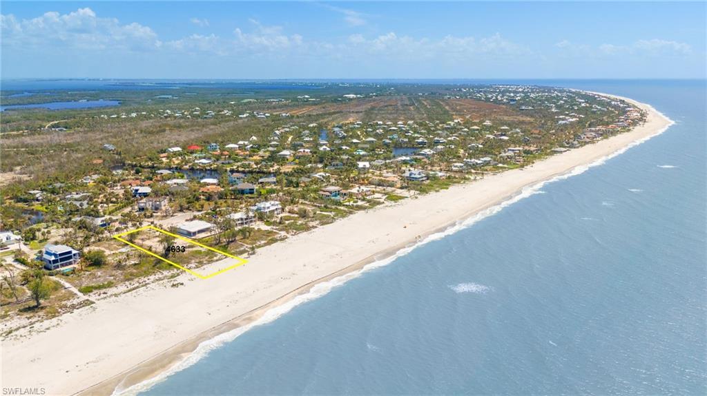 Image 2: Bird's eye view featuring a beach view and a water view