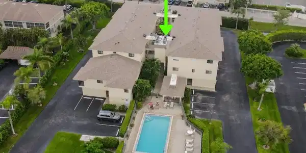 Image 2: Aerial perspective of suburban area with a pool area
