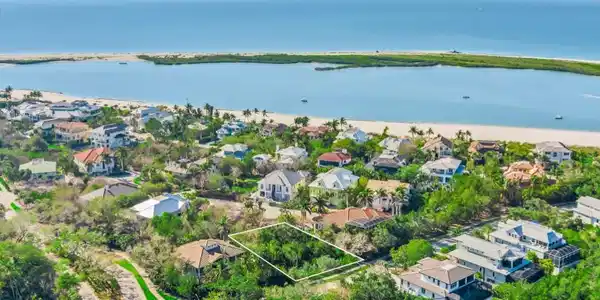 Image 3: Aerial view of residential area featuring a nearby body of water and property boundaries highlighted