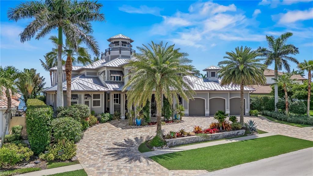 Image 3: View of front of home with a standing seam metal roof, decorative driveway, an attached garage, and a front yard