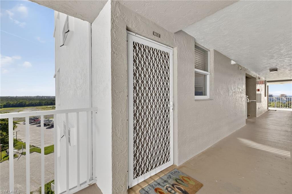 Image 4: View of exterior entry featuring stucco siding