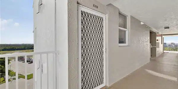Image 4: View of exterior entry featuring stucco siding