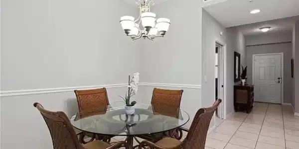 Image 4: Tiled dining area with a chandelier