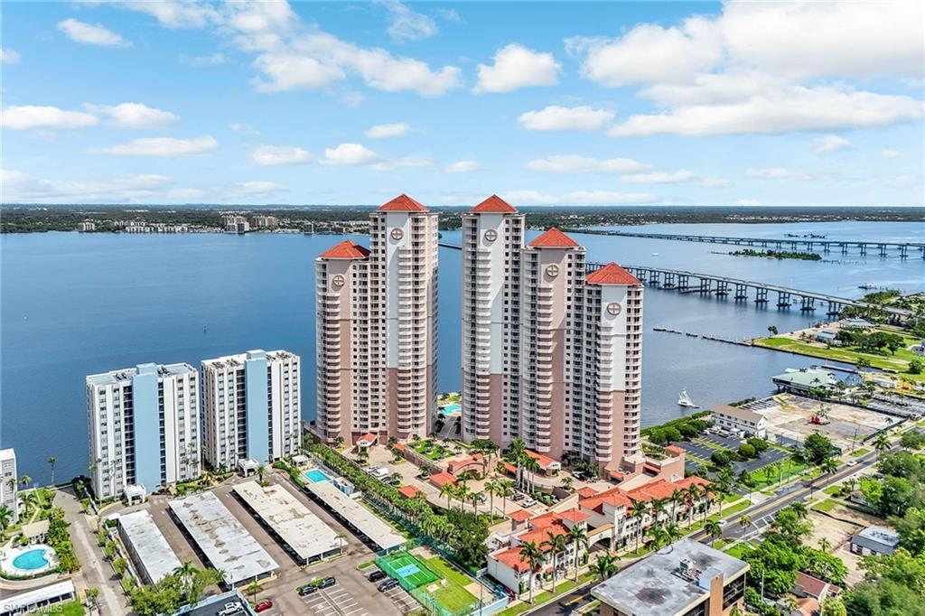Image 1: A sweeping aerial view reveals the prestigious towers nestled perfectly along the Caloosahatchee River.