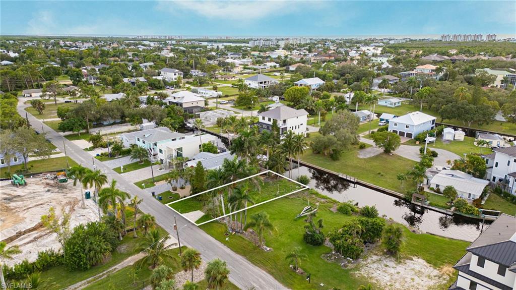 Image 4: Aerial view of property and surrounding area featuring nearby suburban area