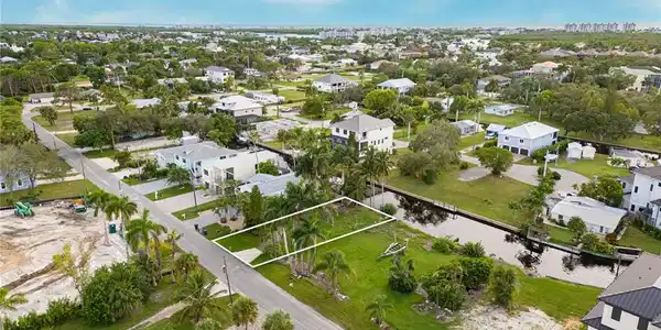 Image 4: Aerial view of property and surrounding area featuring nearby suburban area