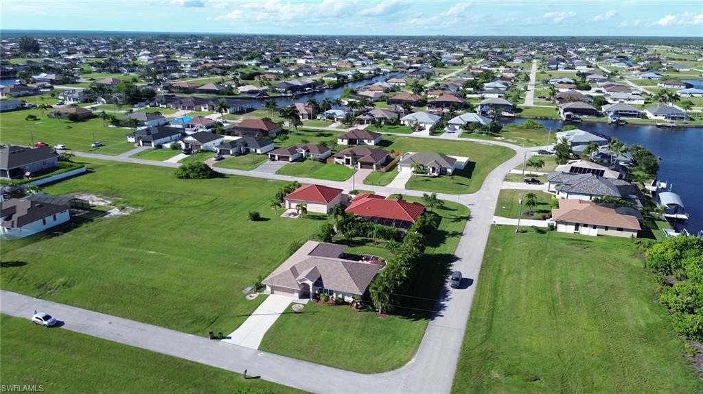 Image 4: View of property location with a nearby body of water and nearby suburban area