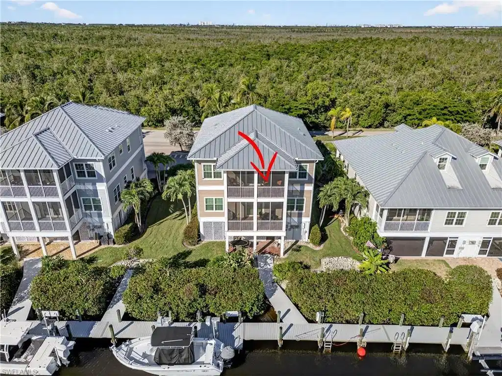 Image 1: View of subject property featuring dock and lush mangroves