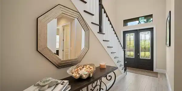Image 3: Entrance foyer featuring wood finished floors, french doors, stairs, and a high ceiling
