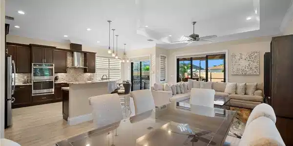 Image 4: Dining area with a chandelier, ornamental molding, a tray ceiling, recessed lighting, and a ceiling fan