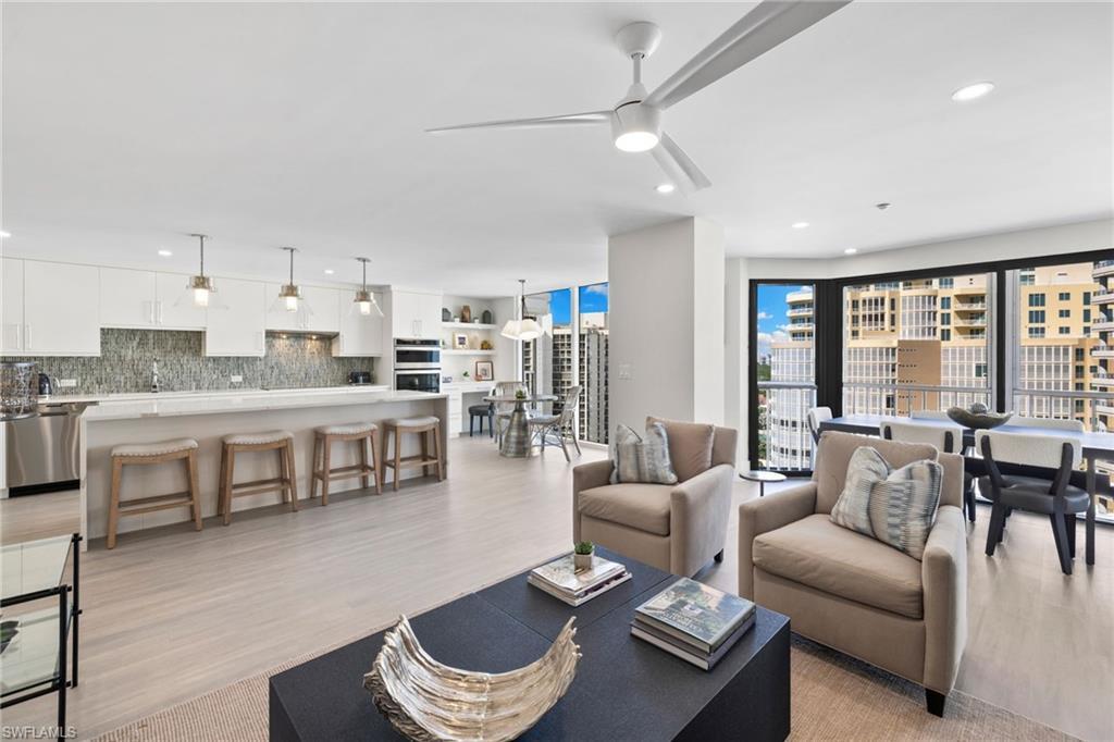 Image 1: Living area featuring light wood-style flooring, ceiling fan, and recessed lighting
