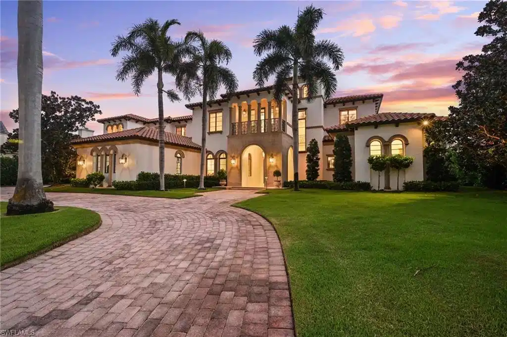 Image 1: Mediterranean / spanish-style house featuring curved driveway, a balcony, and a yard