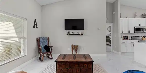 Image 4: Living area featuring vaulted ceiling, recessed lighting, and light marble finish flooring