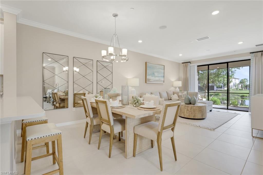 Image 1: Dining area with ornamental molding, recessed lighting, a chandelier, and light tile patterned floors