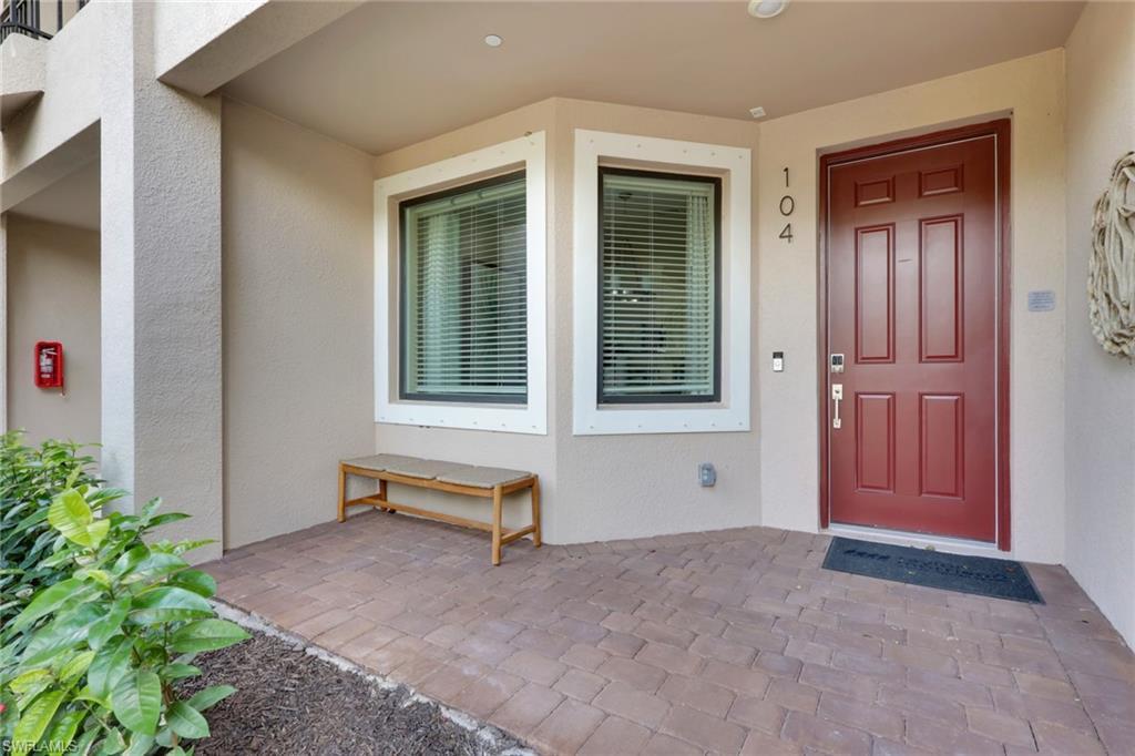 Image 2: View of exterior entry with stucco siding and a porch
