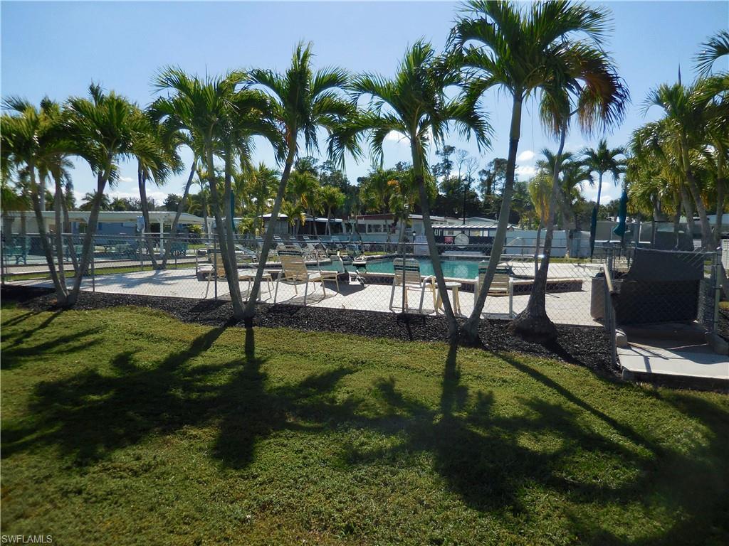 Image 2: View of property's community pool and deck