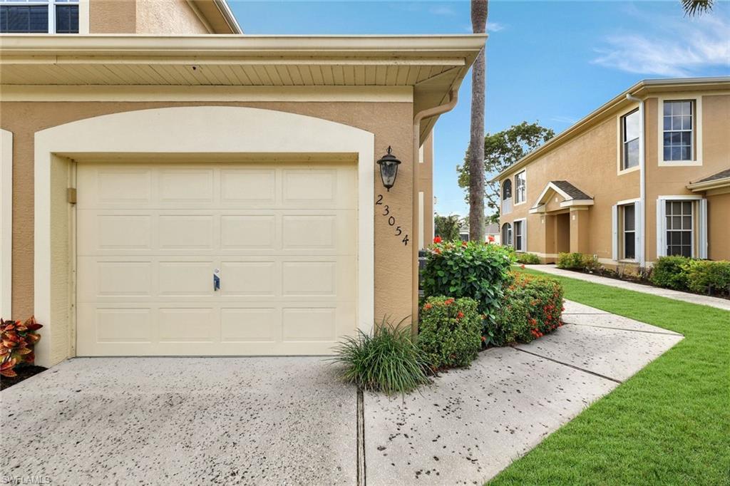 Image 2: Garage featuring concrete driveway