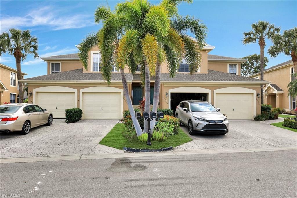 Image 3: Townhome / multi-family property with an attached garage, concrete driveway, and stucco siding