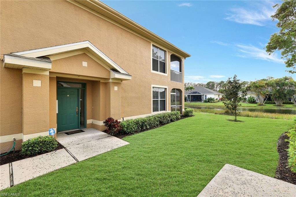 Image 4: Entrance to property featuring a yard, a water view, and stucco siding