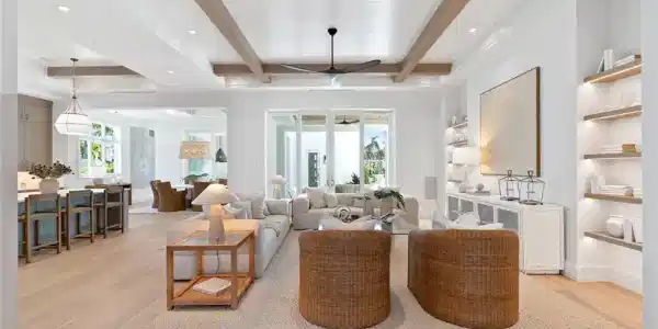 Image 2: Living area featuring plenty of natural light, light wood-style flooring, beamed ceiling, and a ceiling fan