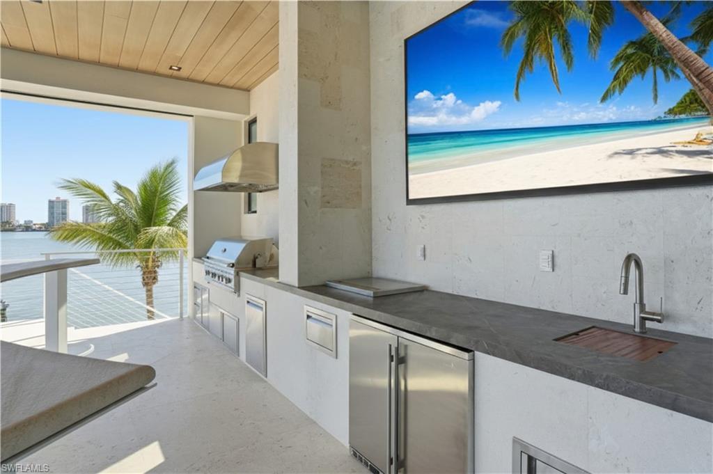 Image 2: Patio / terrace with an outdoor kitchen and a water view